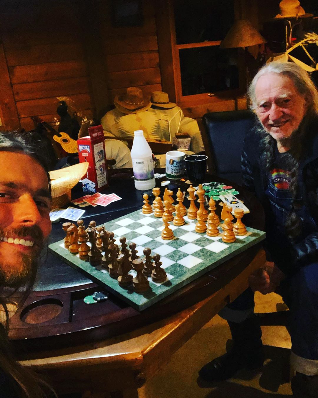 Lukas Nelson and Willie Nelson playing chess