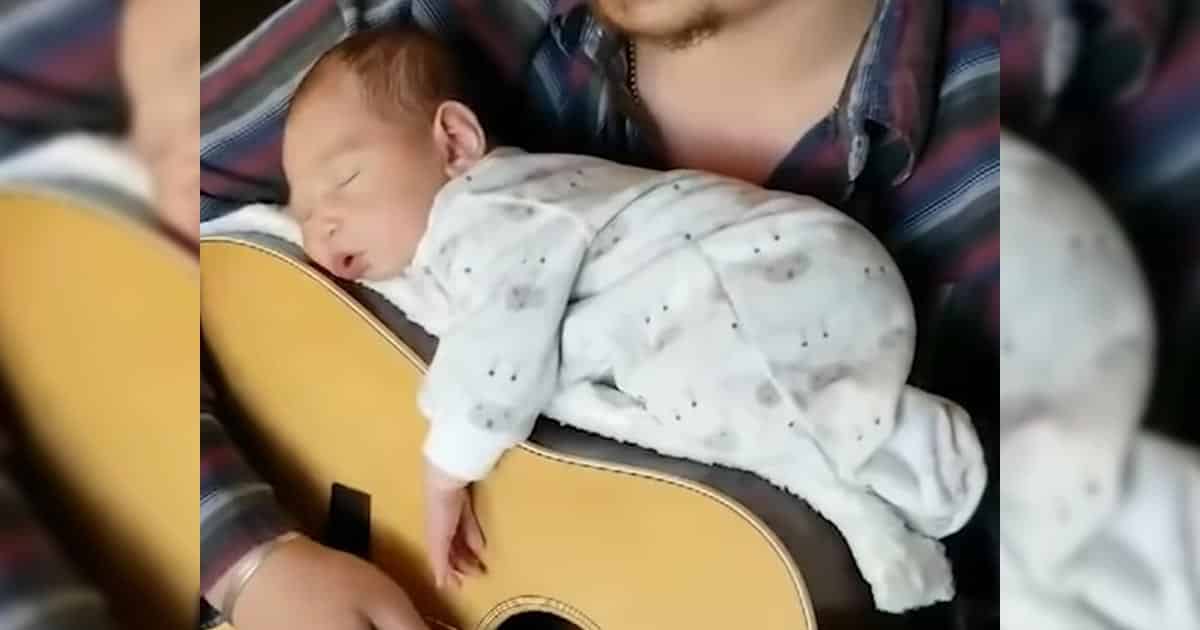 Dad nestles his newborn daughter