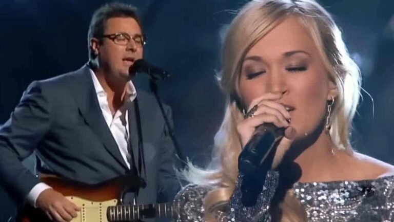 Carrie Underwood and Vince Gill deliver a breathtaking duet of “How Great Thou Art,” with Carrie in a shimmering gown and Vince on guitar, both lost in the reverence of the moment.