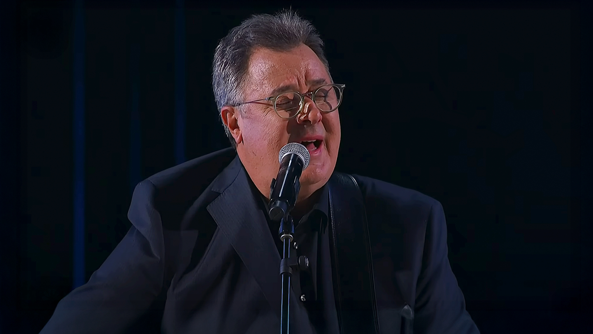 Vince Gill’s voice trembled as he performed Go Rest High on That Mountain at Opry 100, dedicating the song to his mother’s 100th birthday year.