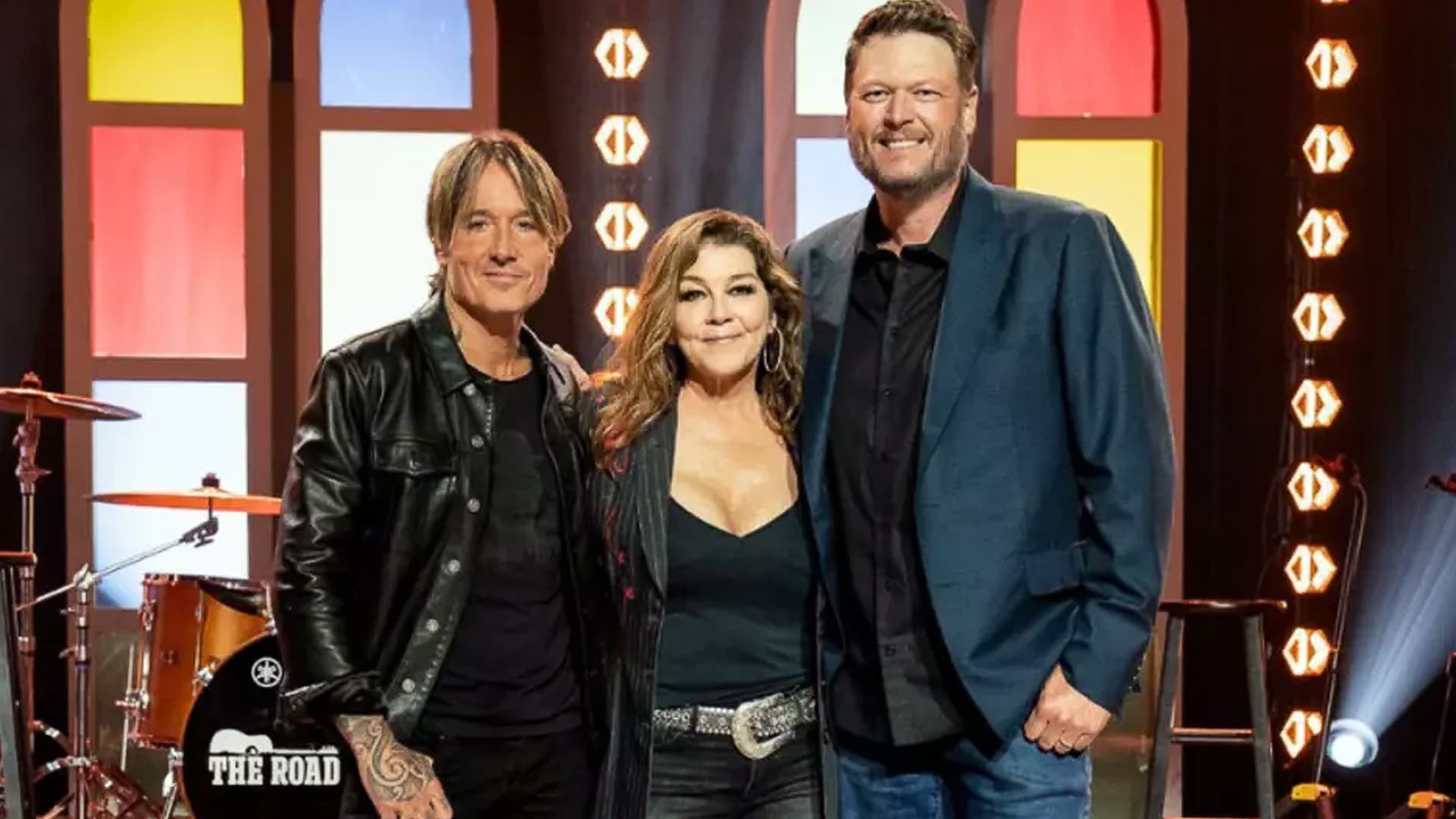 Gretchen Wilson stands between Keith Urban and Blake Shelton on set of their new CBS show The Road, where she’ll serve as tour manager for rising country artists.