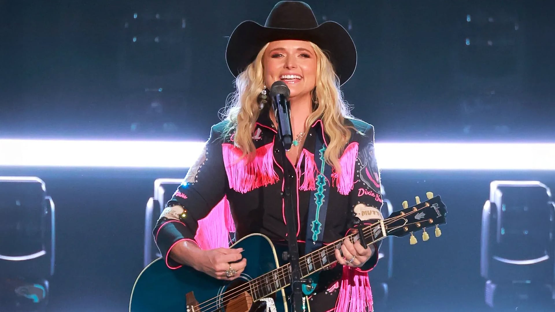 Miranda Lambert performs with a smile in bold pink fringe, still lighting up the stage even as award shows continue to overlook her—leaving fans wondering why the most decorated ACM artist in history isn’t getting the recognition she used to.