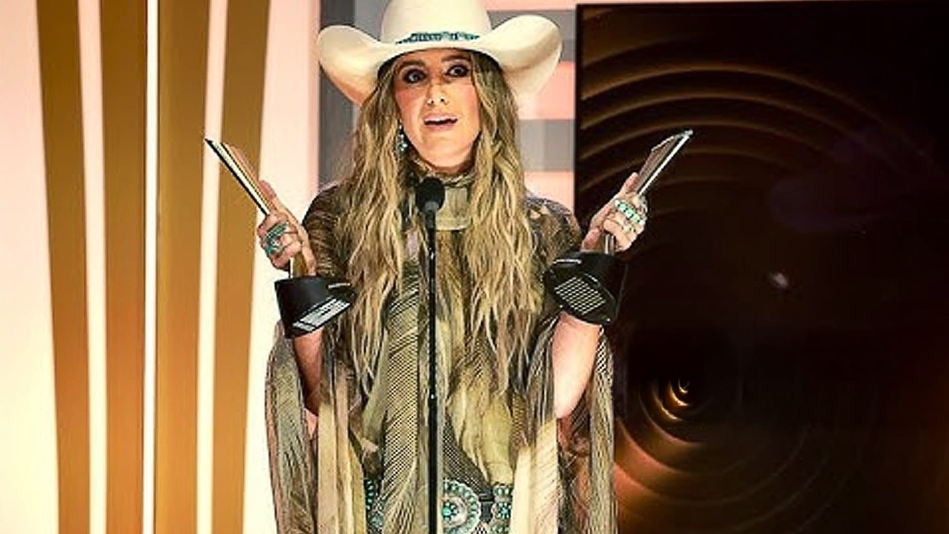 Lainey Wilson holds two ACM Awards on stage, matching predictions that she will dominate the 2025 ACM Awards night.