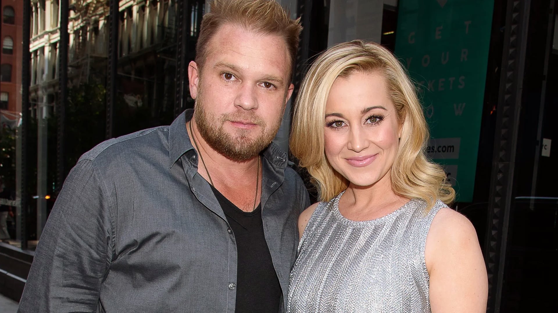 Kellie Pickler and her late husband Kyle Jacobs pose together at an event, both smiling, before the ongoing legal battle with his parents over his cremation and estate.