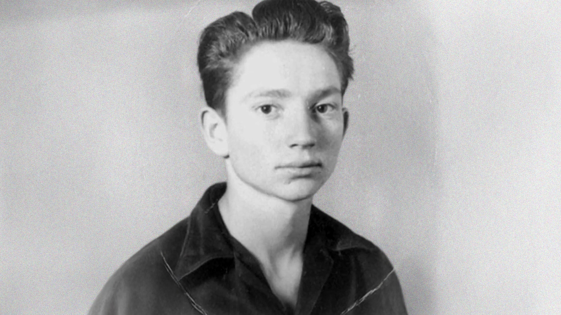 A young Willie Nelson in a black-and-white photo, years before writing his first poem at age six that sparked a legendary country music career.