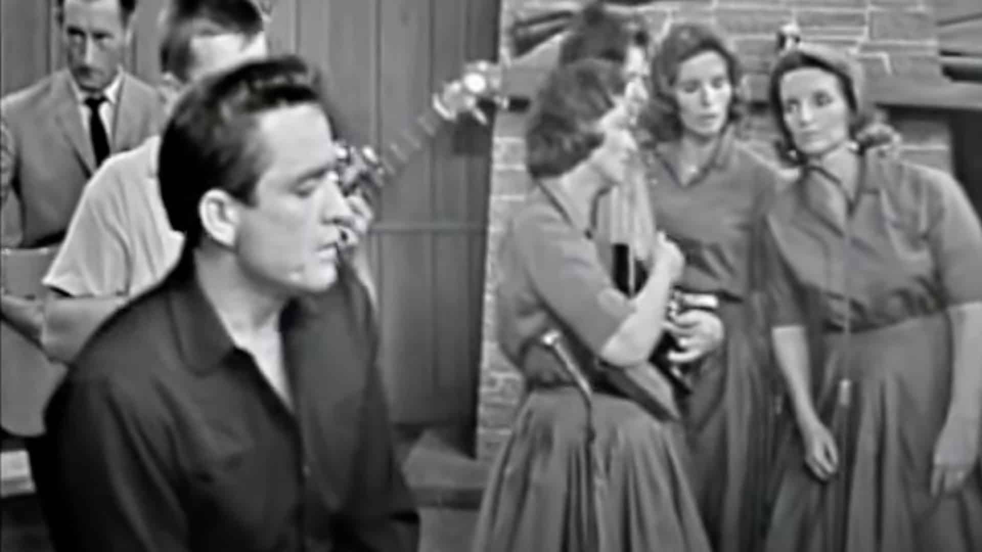 Johnny Cash performs “Were You There” with the Carter Family in a black-and-white televised moment that captures the raw emotion of the gospel hymn.