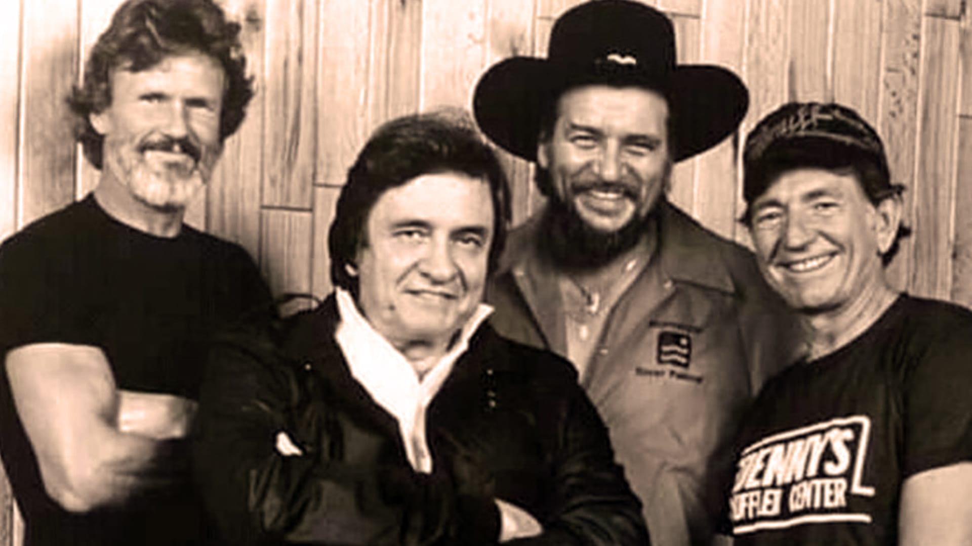 The Highwaymen—Kris Kristofferson, Johnny Cash, Waylon Jennings, and Willie Nelson—pose together, smiling and relaxed, showcasing their legendary camaraderie in country music.