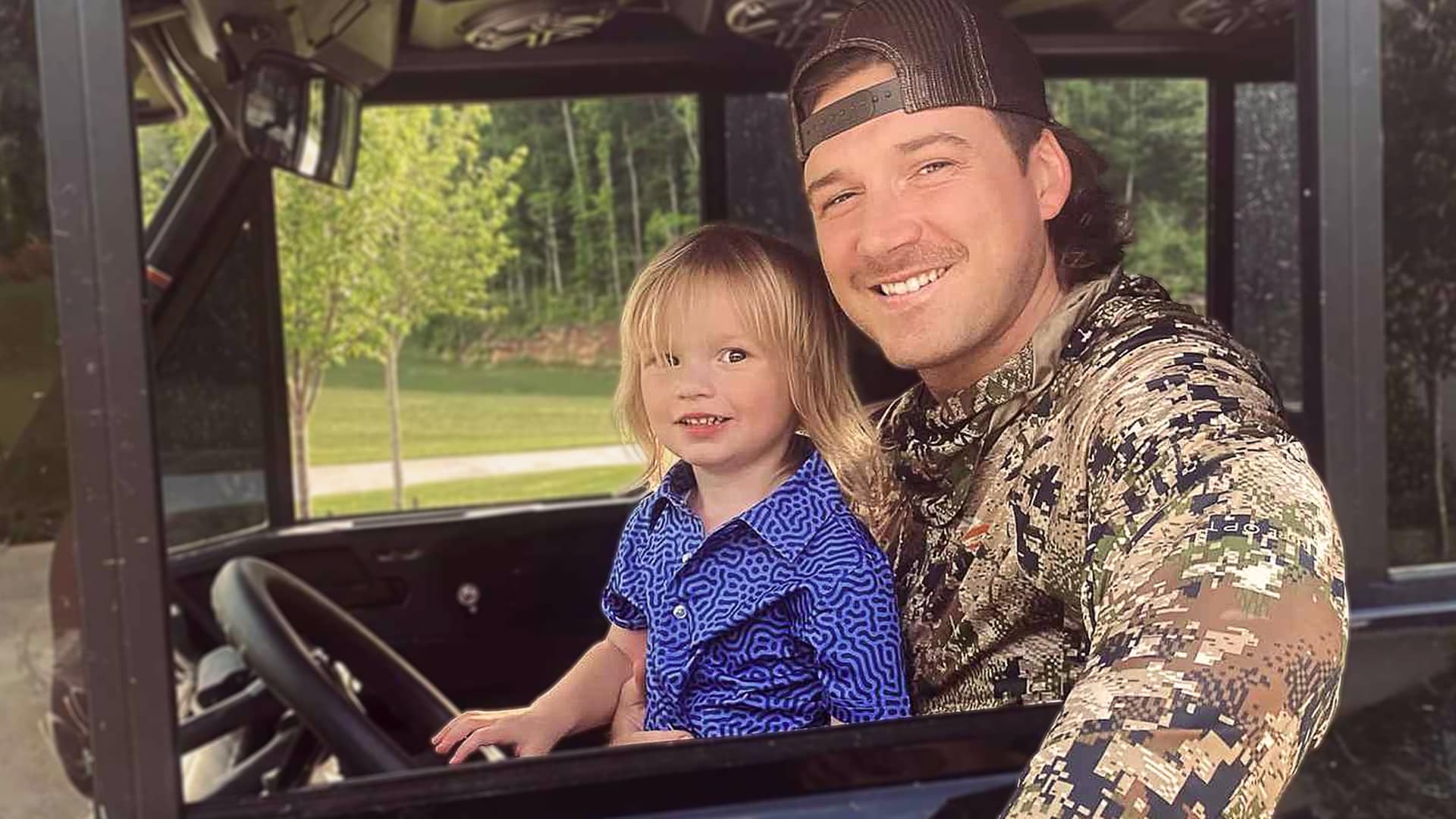 Morgan Wallen sits beside his son in a utility vehicle, smiling as he embraces fatherhood—a turning point that made him more selective about the people in his life.