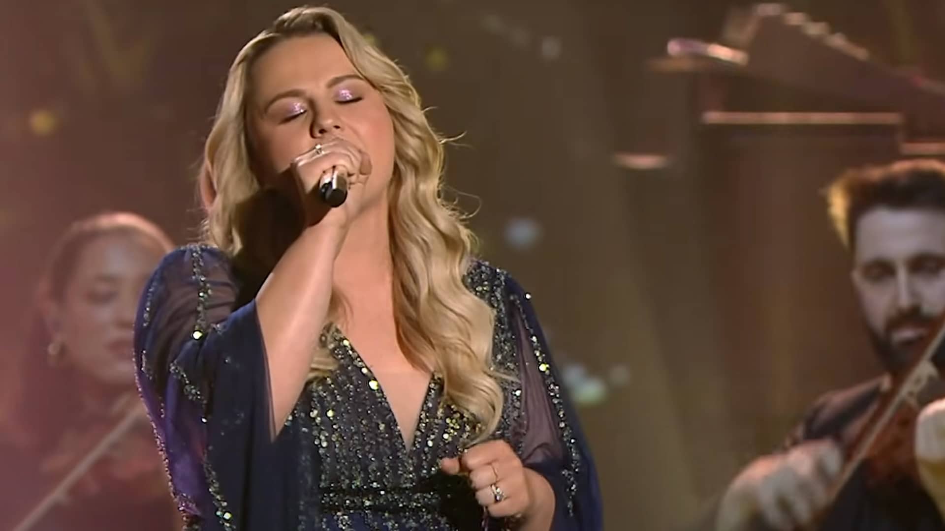 Breanna Nix performs "The Climb" on American Idol in a sparkling blue gown, delivering a powerhouse vocal that rivaled the original.
