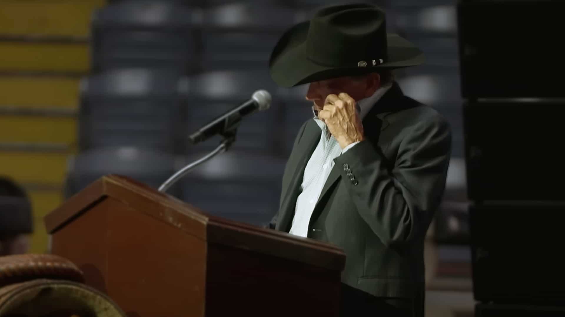 George Strait wipes away tears while speaking at rodeo legend Roy Cooper’s emotional funeral service.