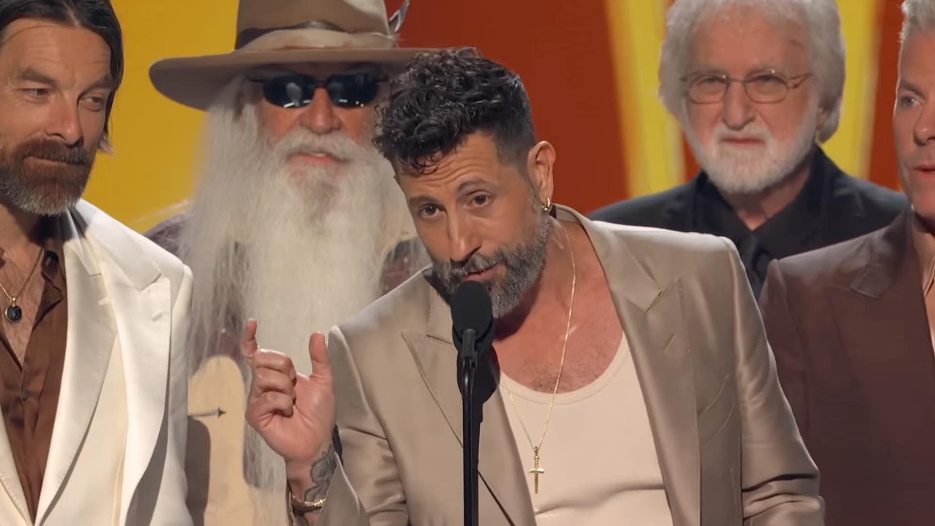 Old Dominion frontman Matthew Ramsey delivers a speech at the 2025 ACM Awards after winning Group of the Year for the eighth consecutive time, flanked by The Oak Ridge Boys.