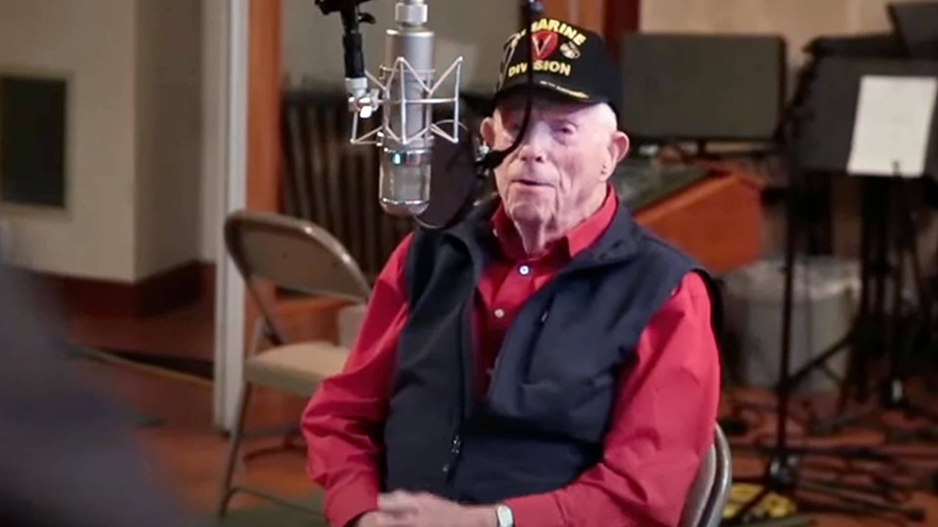 WWII Marine Corps veteran Don Graves, age 100, sits in a Nashville recording studio wearing a military hat and red shirt, having just signed his first country music record deal.