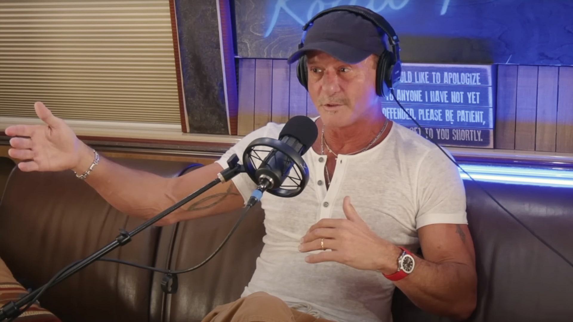 Tim McGraw speaks into a podcast microphone, reflecting on aging in country music and saying he's done singing about bikinis and tailgate parties at 58.