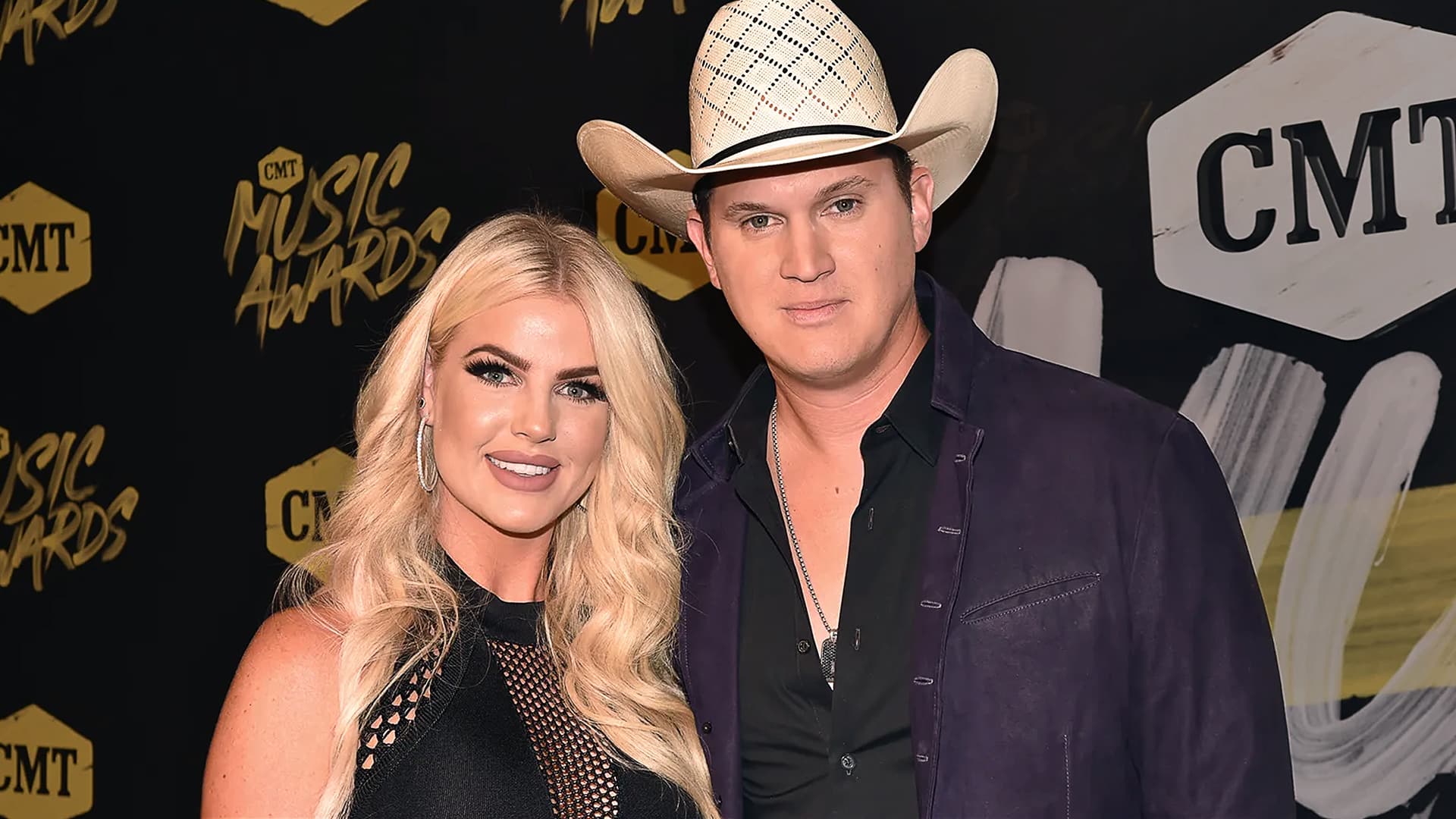 Jon Pardi and his wife Summer Pardi smile on the red carpet at the CMT Music Awards, showing off their down-to-earth charm and country style.