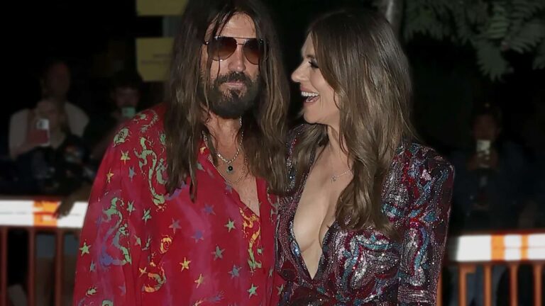 Billy Ray Cyrus and Elizabeth Hurley light up the red carpet with a bold kiss at the London premiere event.
