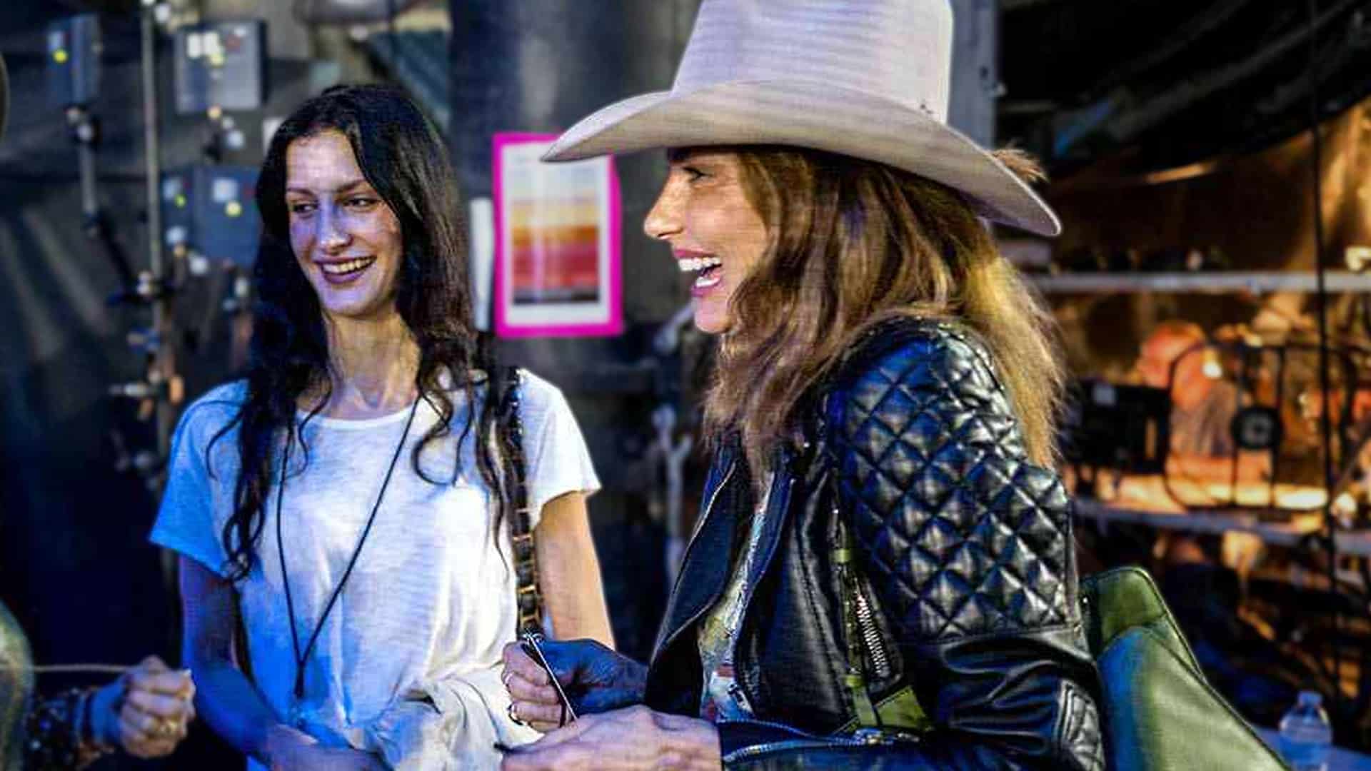 Faith Hill beams backstage at CMA Fest 2025 in her first public appearance in two years, wearing a wide-brim hat and leather jacket while chatting with friends.