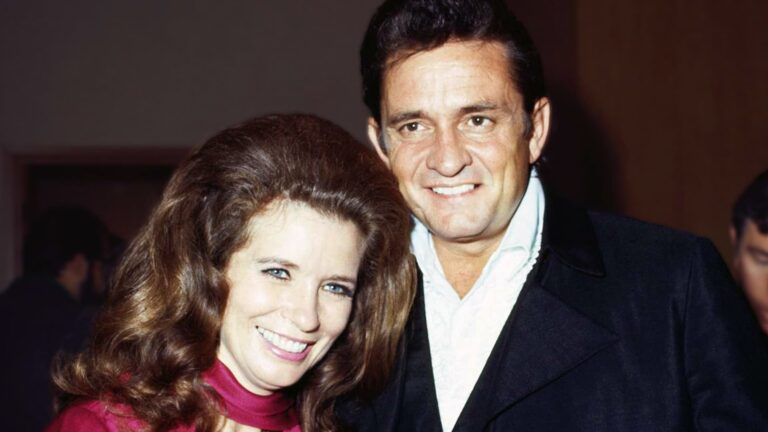 Johnny Cash and June Carter smile side by side in a vintage photo, capturing the warmth and legacy of their iconic love story.