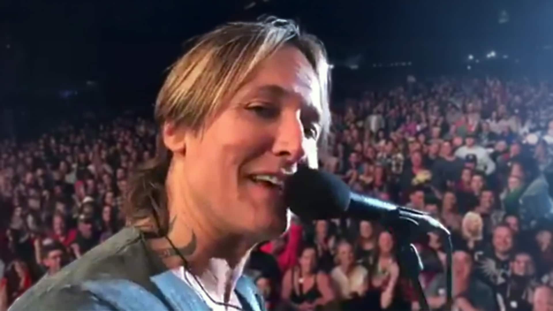 Keith Urban turns to the camera during a packed festival show as thousands of fans sing "Happy Birthday" to Nicole Kidman.