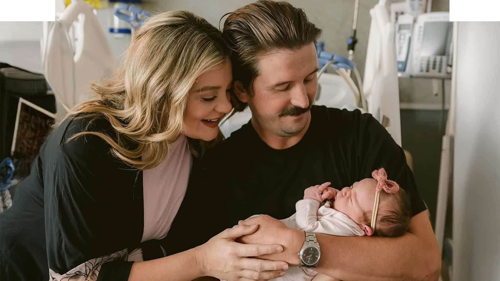 Lauren Alaina and husband Cam Arnold cradle their newborn daughter Beni Doll Arnold in a hospital room, sharing a joyful family moment just after her birth on June 11.