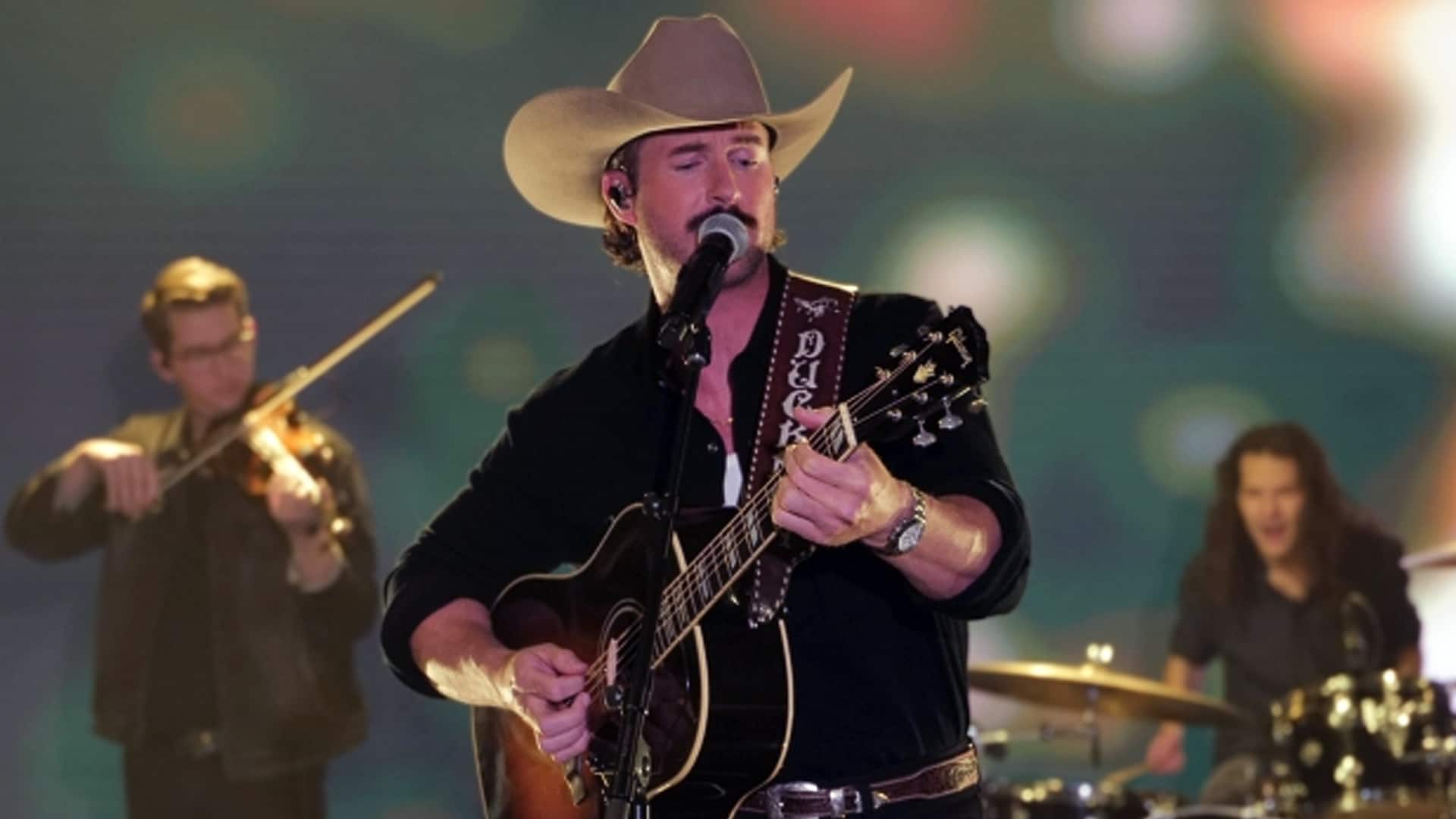 Riley Green performs on stage in a recent show. While this moment isn’t from his interview, it comes as fans continue to speculate about his relationship status—which he recently set straight.