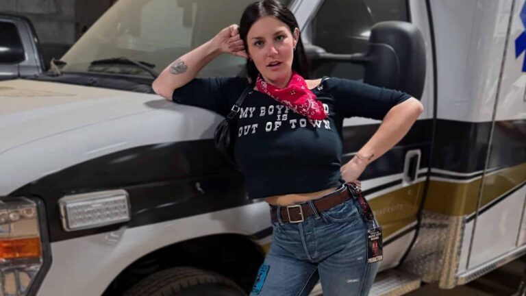 Gracie McGraw stands confidently in front of a truck wearing a bold outfit and bandana after speaking out on social media.