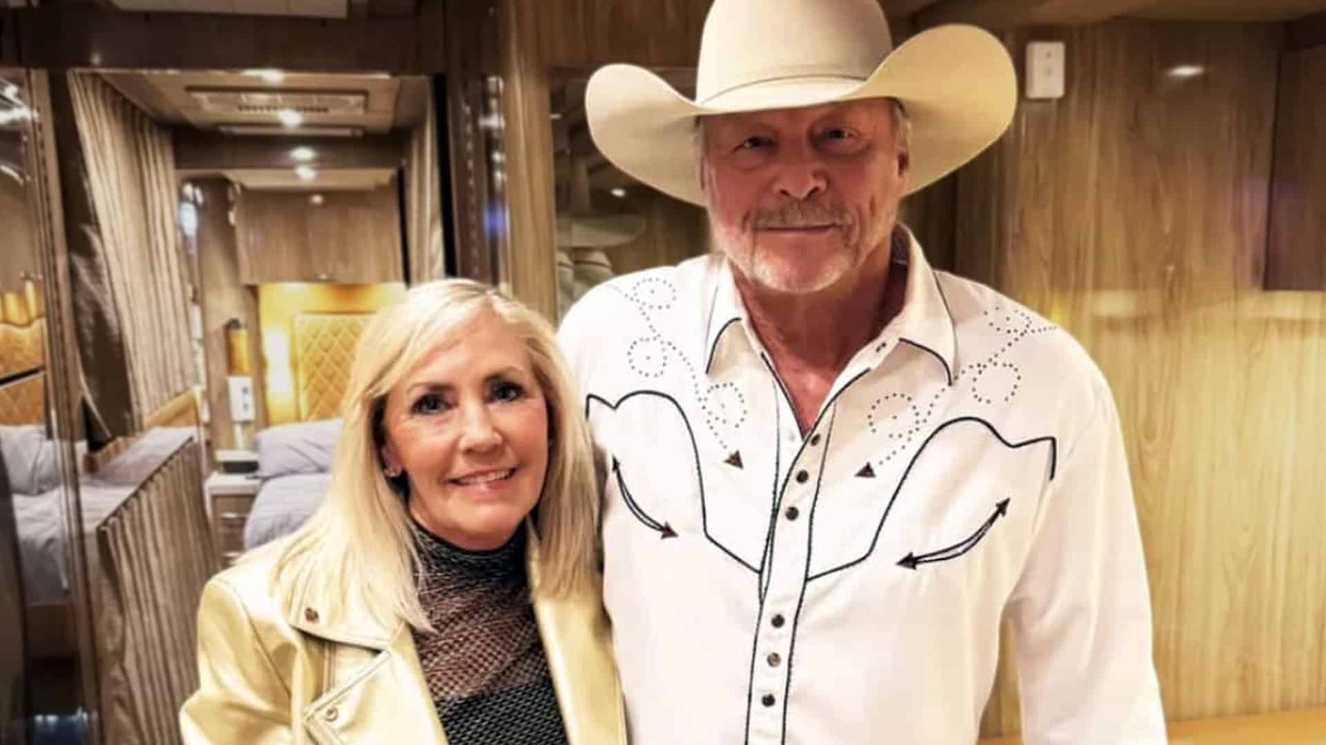 Alan Jackson and Denise pose side by side in a warmly lit tour bus, a quiet moment that speaks volumes about their 40-year love story rooted in faith, forgiveness, and country grace.