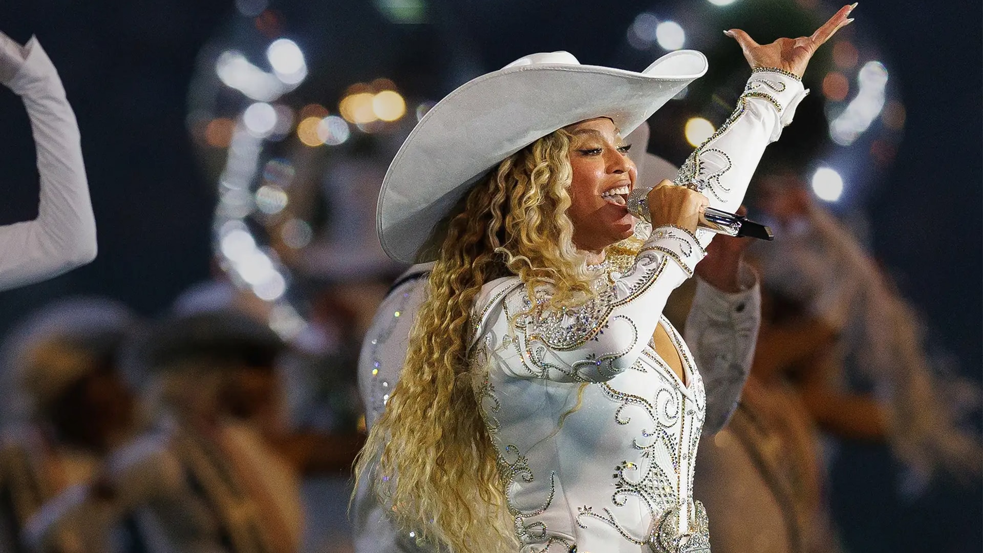 Beyoncé performing in a white rhinestone outfit and cowboy hat during her Cowboy Carter Tour, amid news her unreleased music and setlists were stolen from a car in Atlanta.
