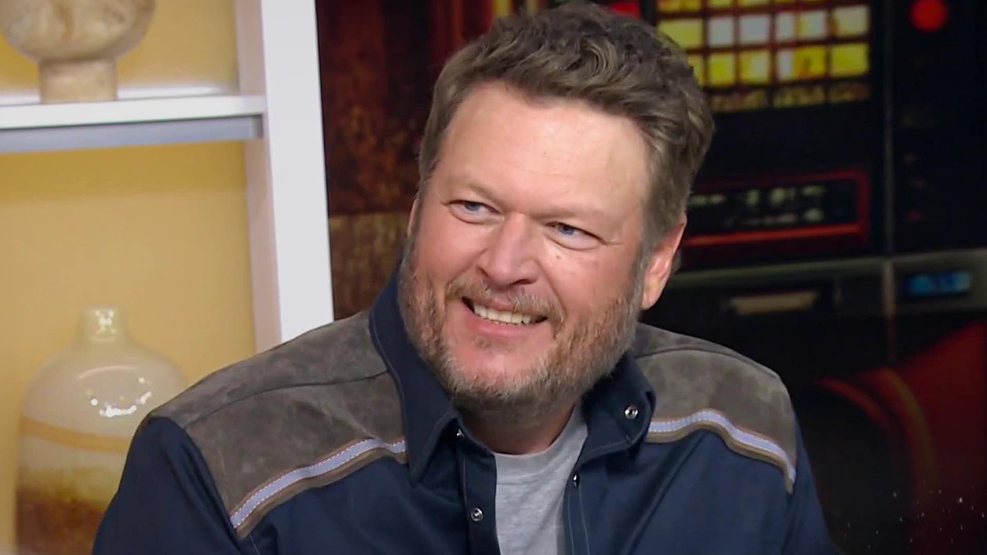 Blake Shelton smiles during an interview as he discusses why he hopes no one covers his songs, mixing humor with honesty.