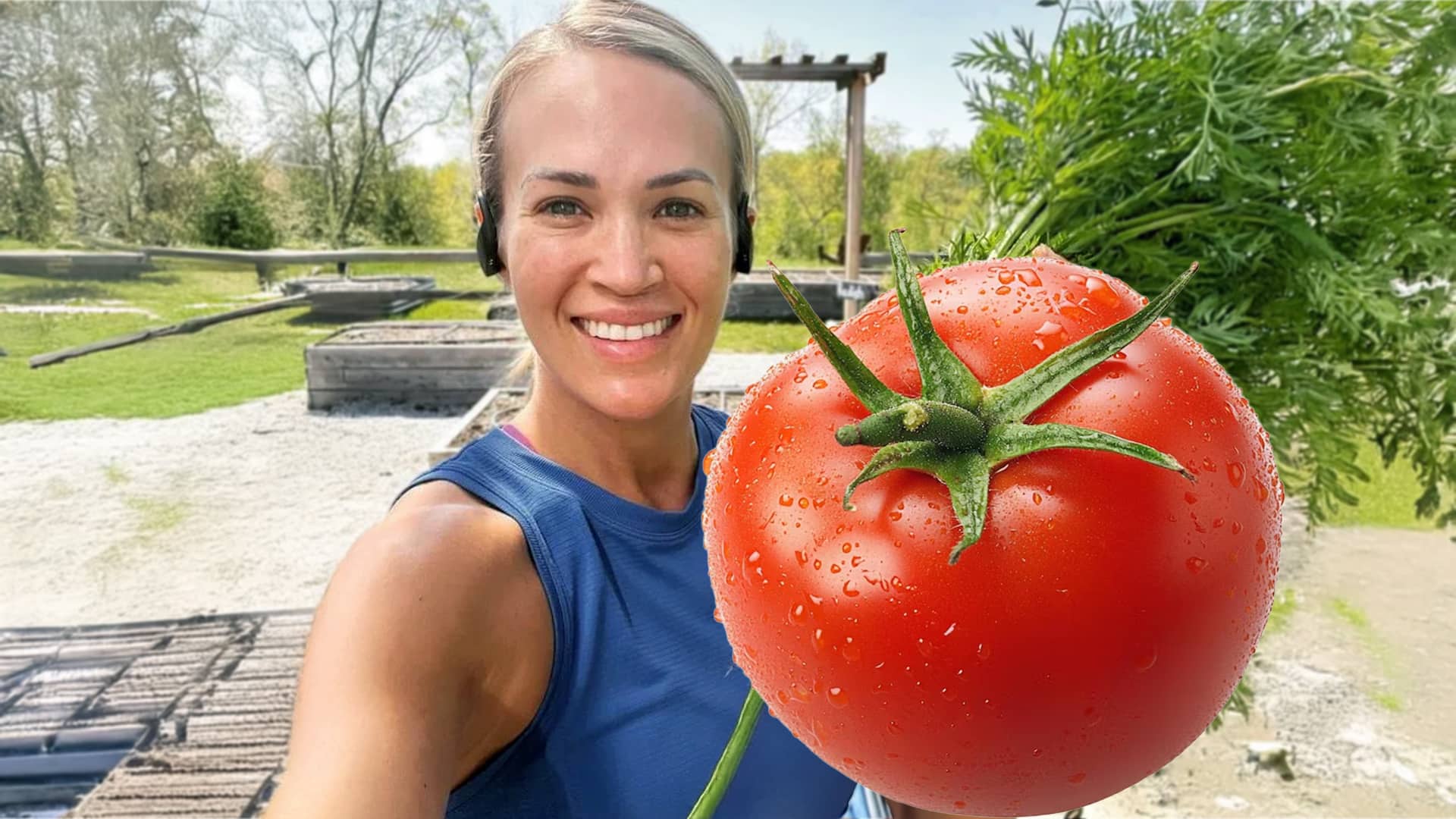 Carrie Underwood smiles in her garden while holding a massive, 2.6-pound tomato that's nearly the size of her head, sparking online buzz.
