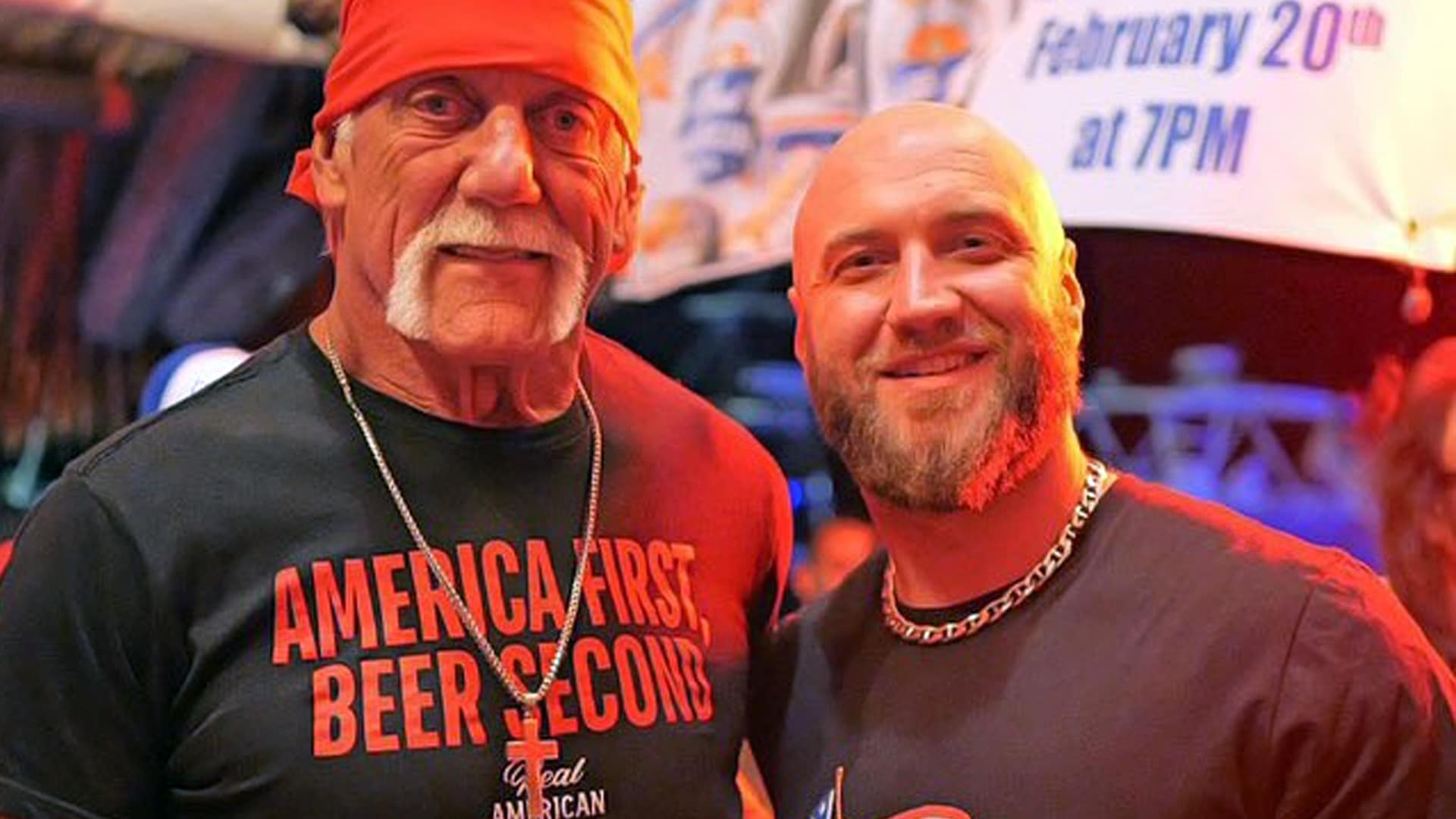 Nick Hogan stands beside his father, Hulk Hogan, both smiling in a bar setting shortly before Hulk's passing, capturing their strong father-son bond.