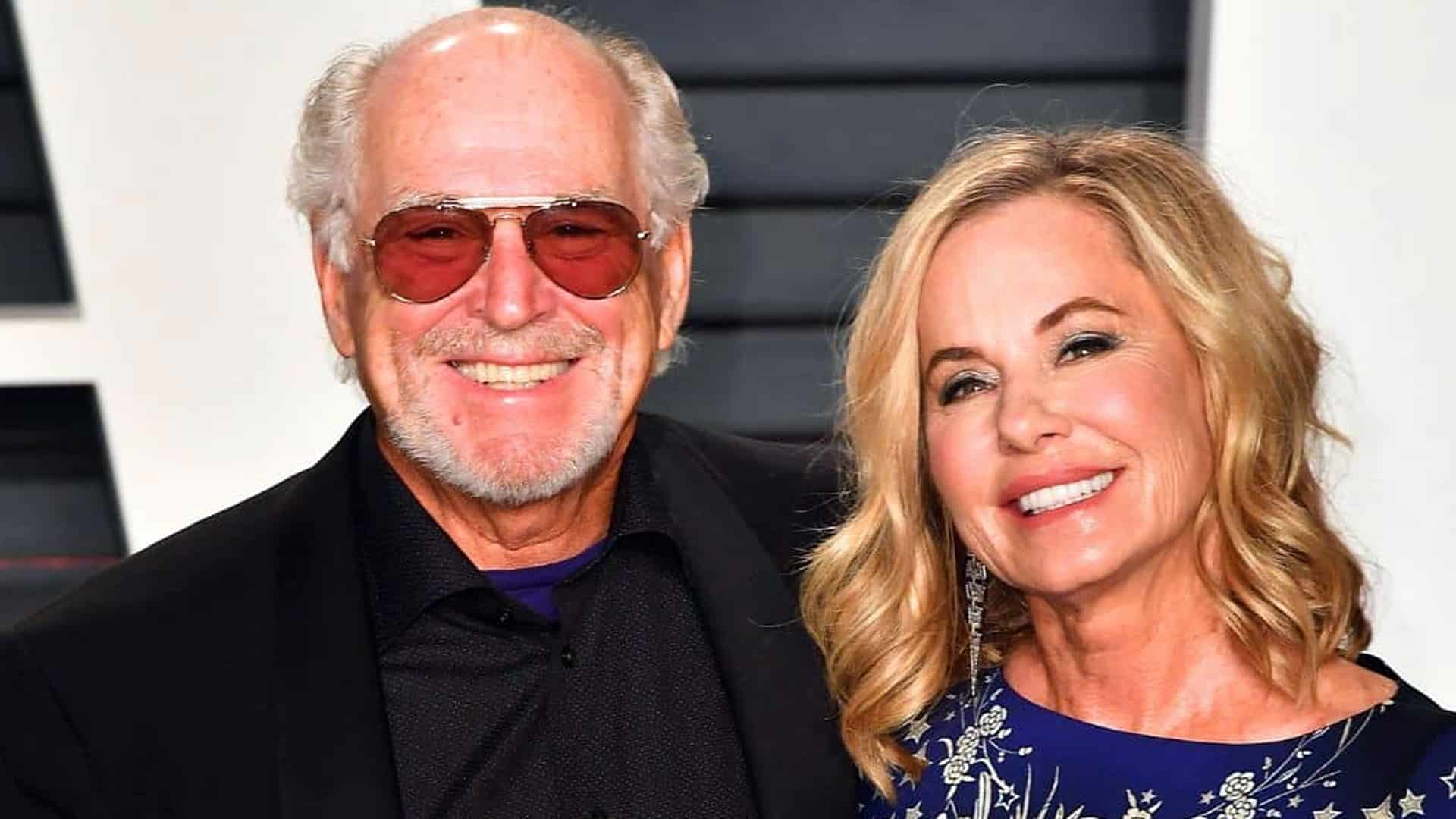 Jimmy Buffett and Jane Slagsvol smile side by side, capturing the warmth and enduring love behind their decades-long laid-back romance.
