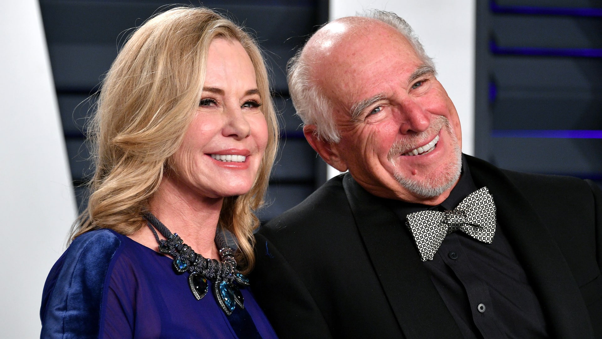 Jane Buffett stands smiling beside the late Jimmy Buffett, now fighting to protect his $275 million estate from alleged mismanagement.