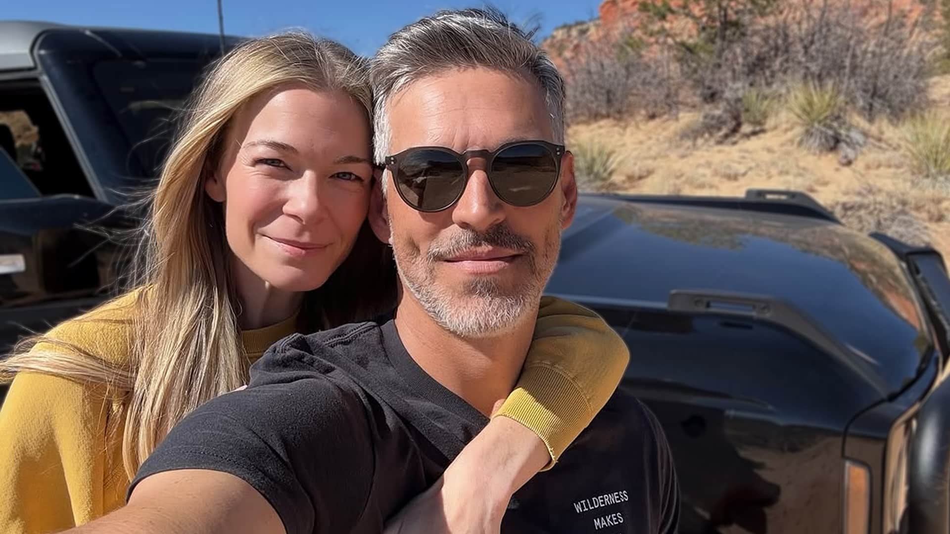 LeAnn Rimes and Eddie Cibrian smiling outdoors, not taken when she spoke about feeling hated after their affair scandal.