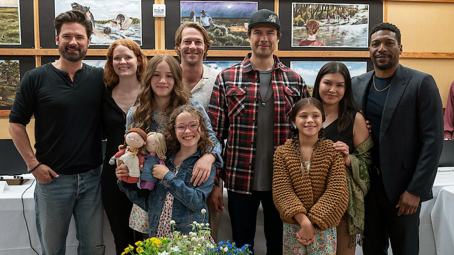 The cast of Netflix’s Little House on the Prairie reboot gathers with smiles and frontier flair, teasing the bold return of a TV classic.