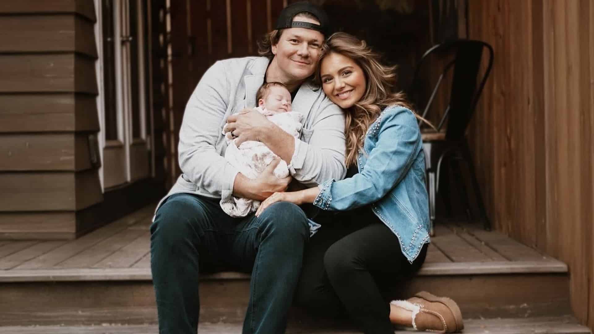 Emmy Russell and husband Tyler Ward sit lovingly with their baby girl Taylor Raydiant, who was recently hospitalized with infantile spasms.