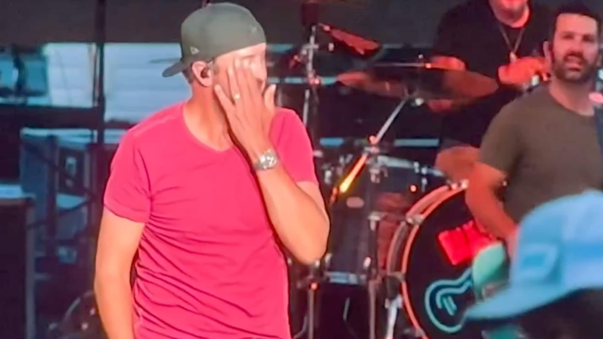 Luke Bryan reacts after getting hit in the face on stage during a live performance at the North Dakota State Fair.