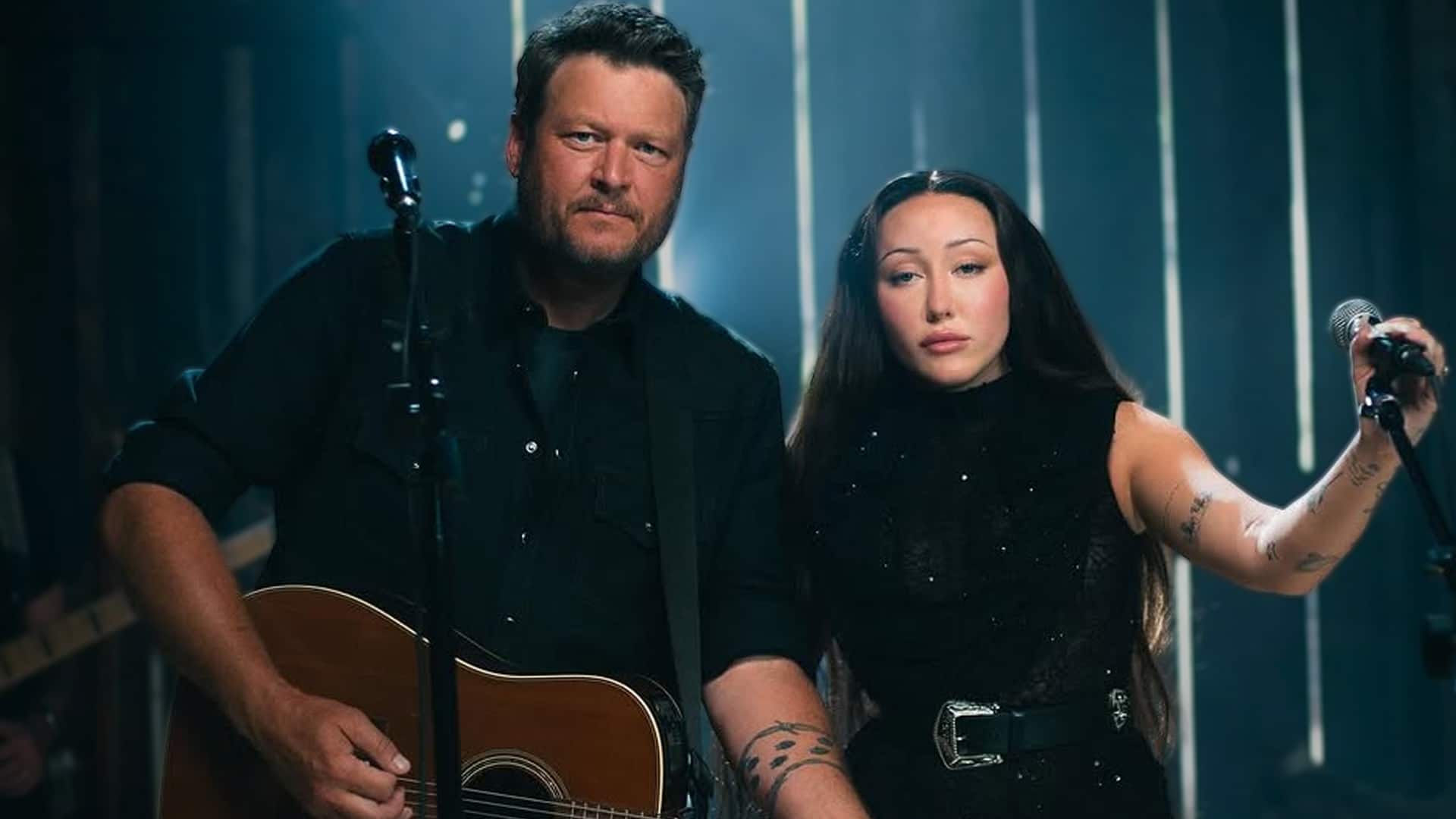 Blake Shelton and Noah Cyrus standing side by side with microphones, performing their new country duet together.