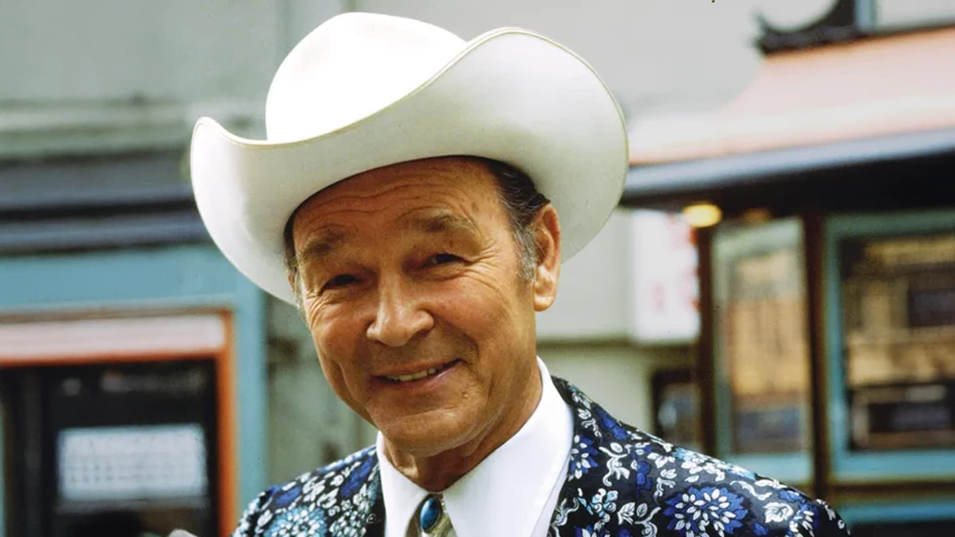 Roy Rogers, smiling in his signature cowboy hat and embroidered suit, remembered by fans as the King of the Cowboys in 1998.