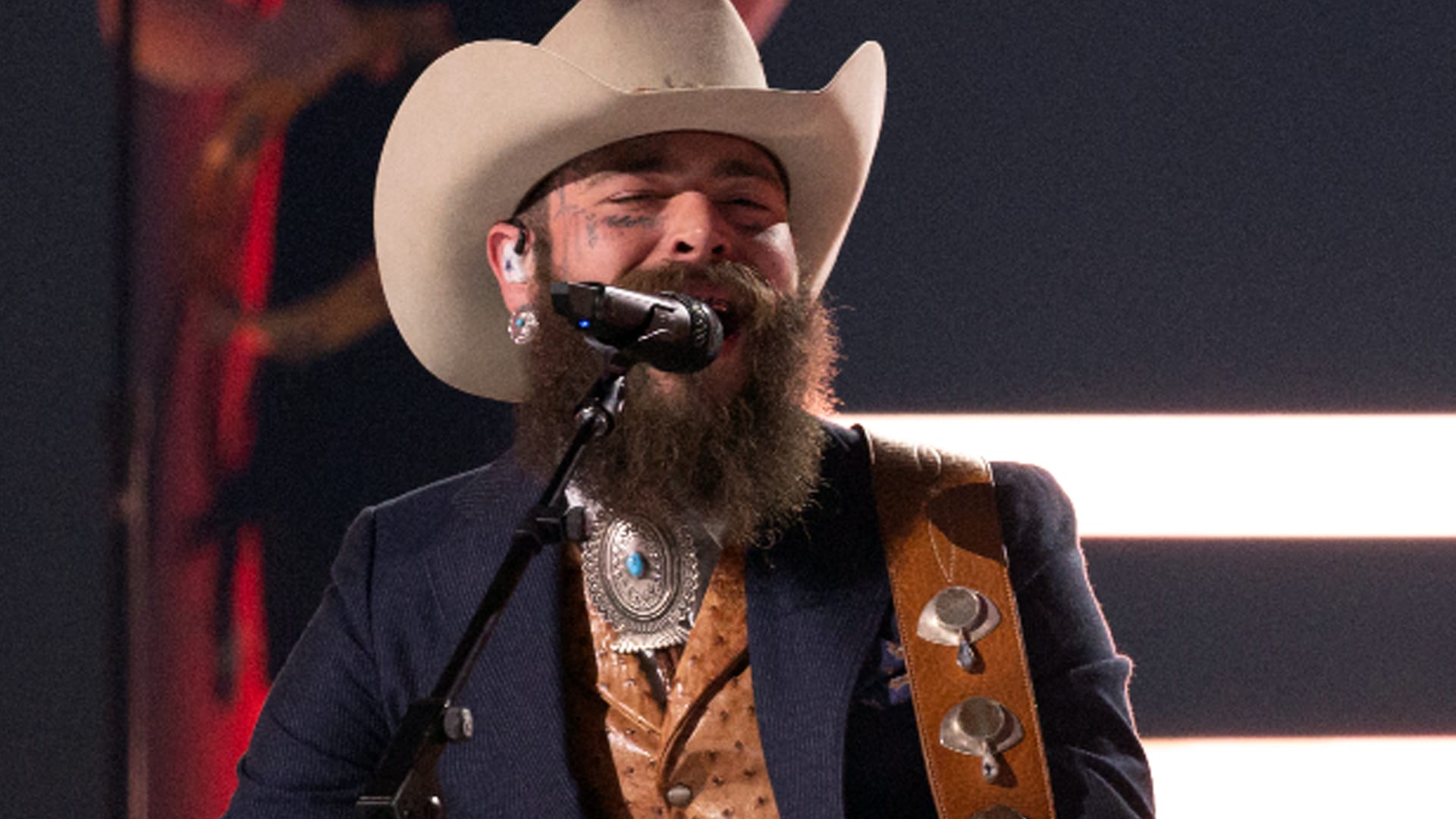 Post Malone performs onstage in a previous show, now making headlines in 2025 for a major custody case victory in Utah over his daughter.