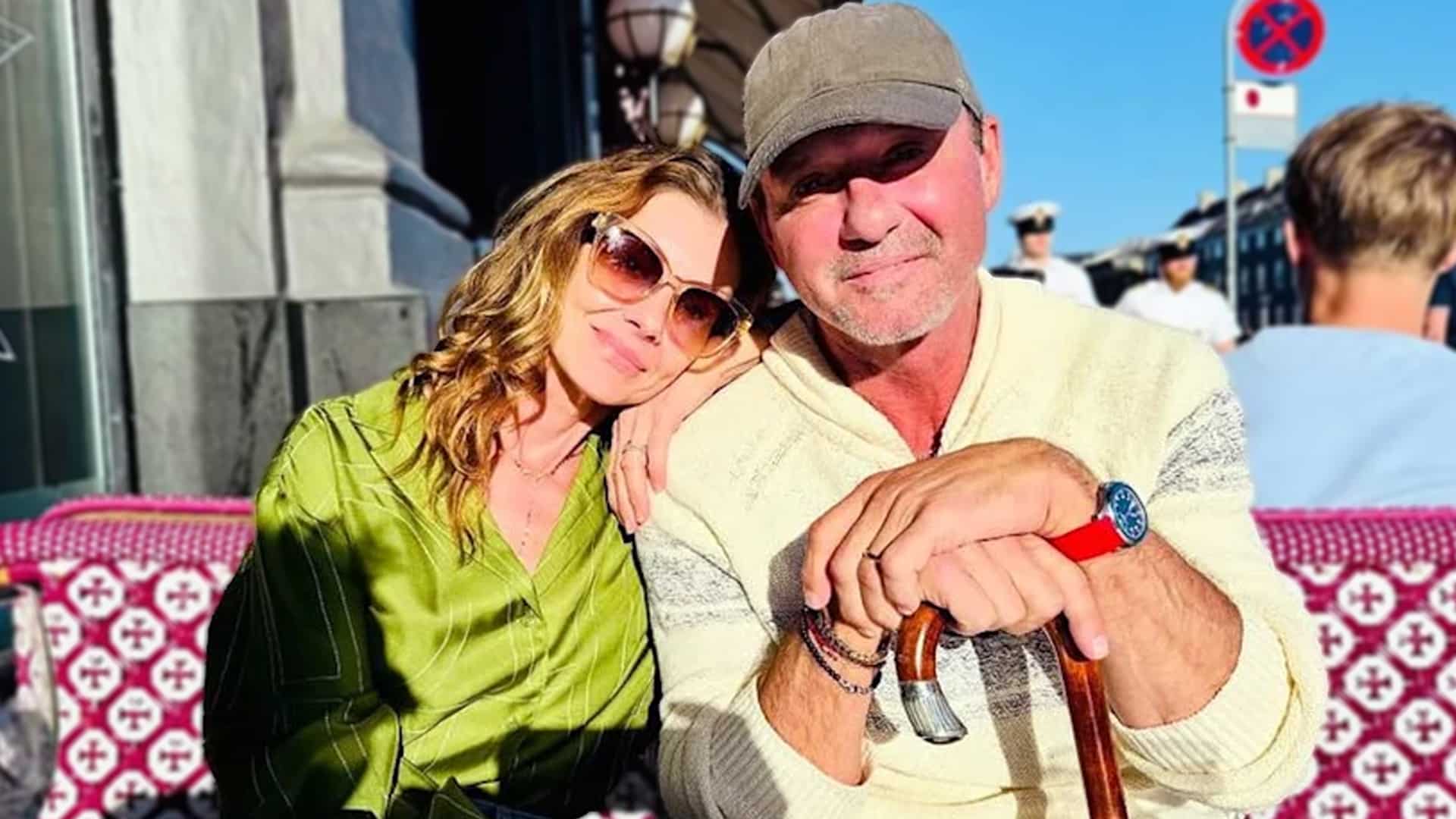 Tim McGraw sits outdoors with Faith Hill, leaning on a cane, sparking questions about his health but showing their strong bond.