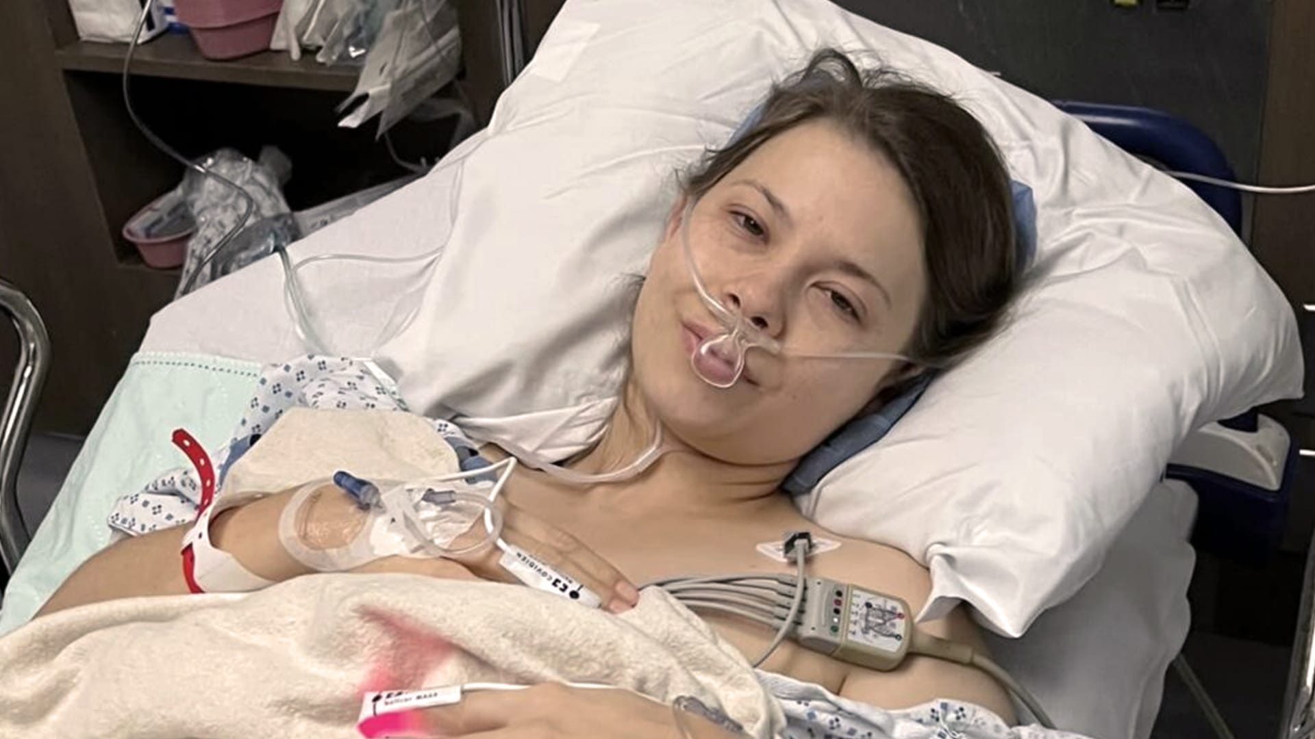 Bindi Irwin rests in a hospital bed with oxygen and monitors after undergoing two surgeries to remove 51 endometriosis lesions.