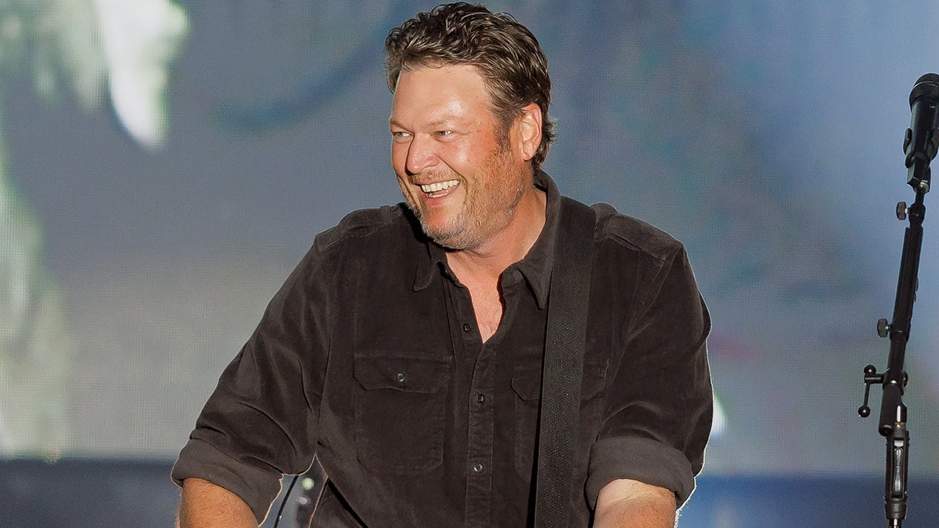 Blake Shelton flashes a big smile onstage, perfectly capturing the playful side that longtime friend Jay DeMarcus reveals through never-before-heard stories.