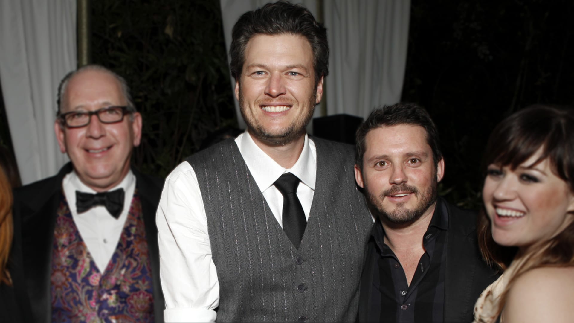Blake Shelton smiles beside Brandon Blackstock at an event, years before their professional and personal relationship came to an end.