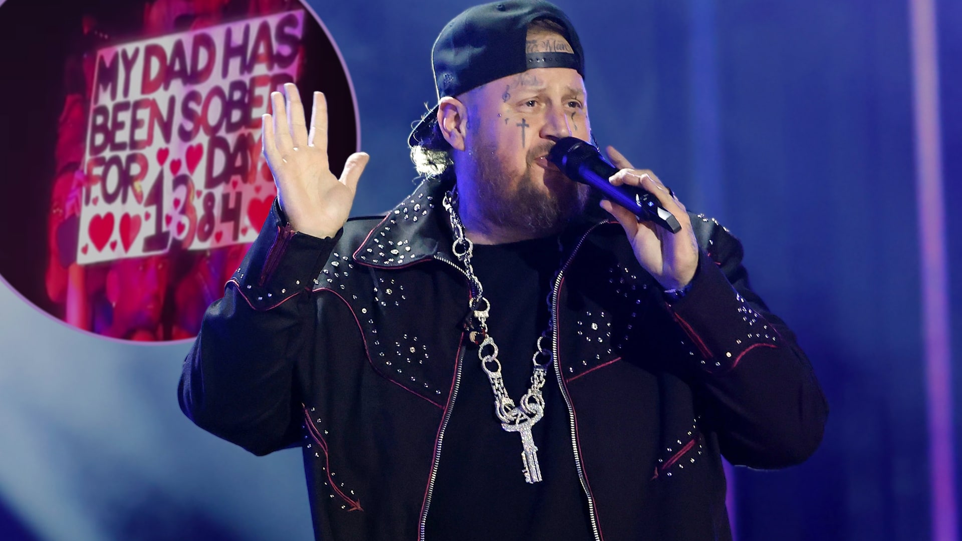 Jelly Roll performing onstage with a fan’s sign in view celebrating her dad’s 1,384 days of sobriety, a moment that stopped the show in Montreal.