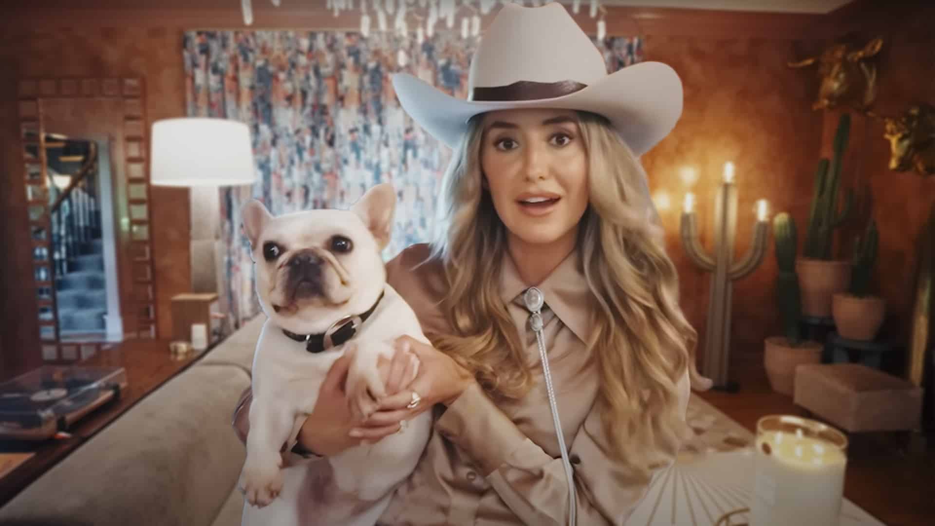 Lainey Wilson gives a tour of her Nashville home, holding her dog in a living room decorated with Southern charm and vintage Americana style.