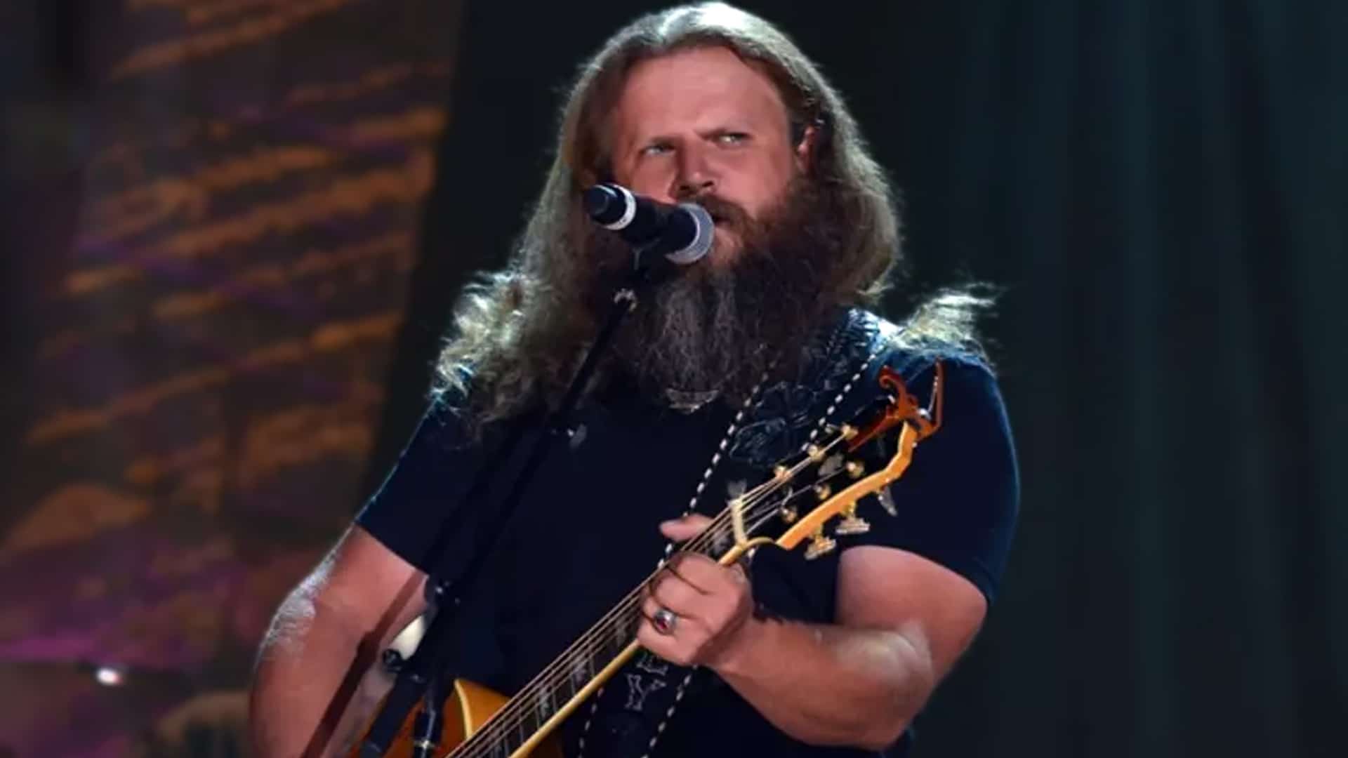 Jamey Johnson singing with emotion during a live performance, tied to his mourning tribute for Charlie Kirk.