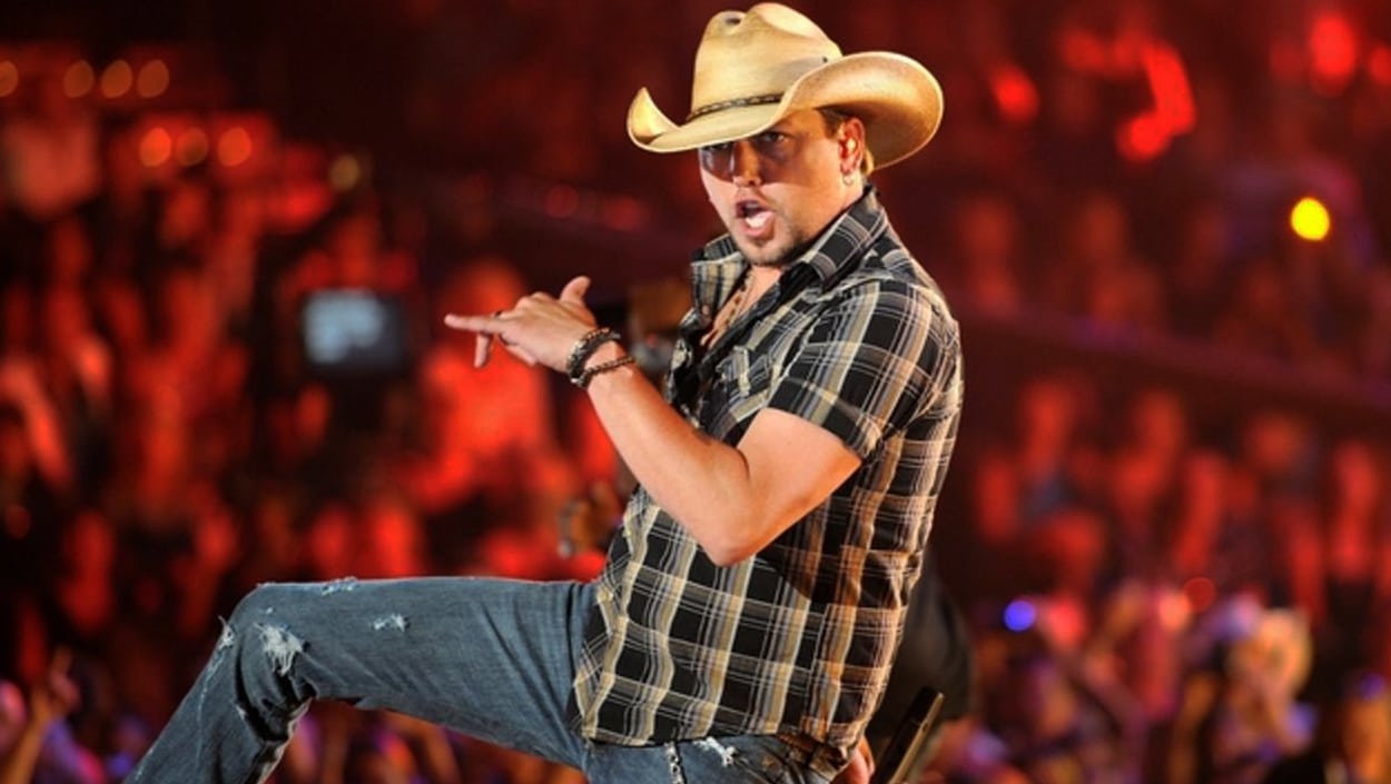 Country singer Jason Aldean onstage, rocking ripped jeans and plaid while owning the hit “Lights Come On,” a song almost given away.