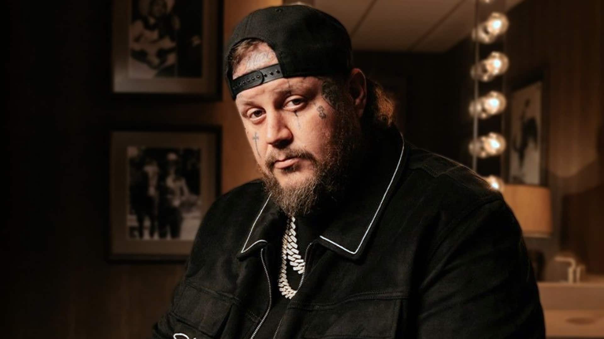 Jelly Roll wearing a black jacket and cap, showing off his slimmer look after losing 110 pounds.