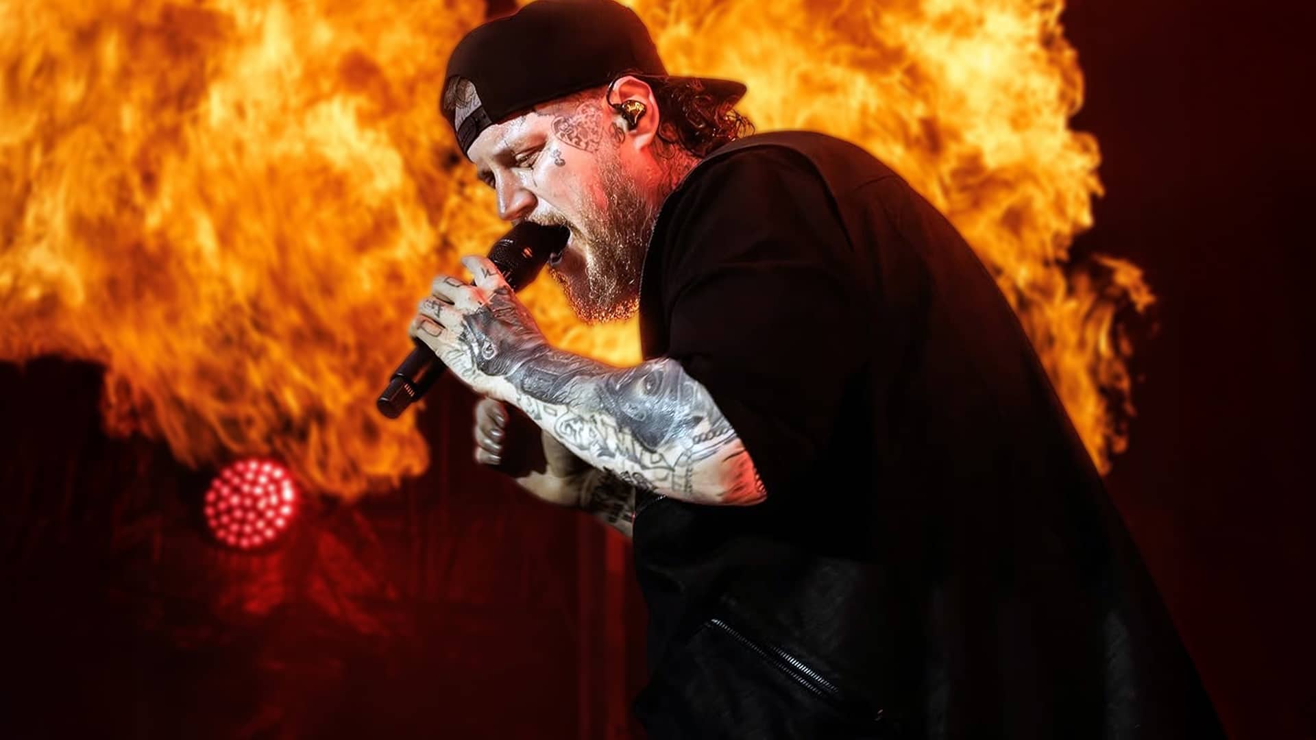 Jelly Roll performing with fiery intensity onstage, his dramatic 200-pound weight loss fueling buzz on his first European tour.