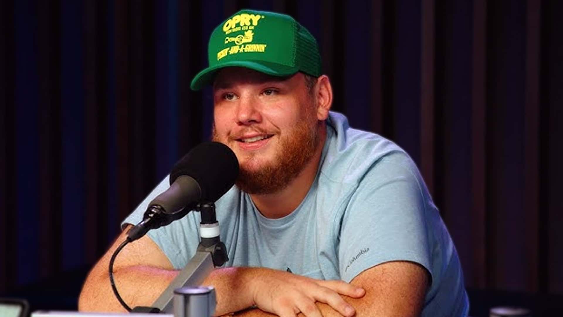 Luke Combs speaks into the mic, opening up about fatherhood and comparing parenting to a knockout punch.
